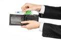 Money and business topic: hand in a black suit holding a wallet with 100 euro banknotes isolated on white background in studio Royalty Free Stock Photo