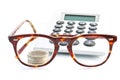 Money, calculator and glasses