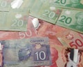 Money from Canada: Canadian Dollars. Full frame of bills spread on table and assorted amounts