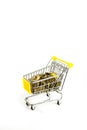 the money cart is isolated on a white background. a shopping basket filled with gold coins Royalty Free Stock Photo