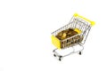 the money cart is isolated on a white background. a shopping basket filled with gold coins Royalty Free Stock Photo