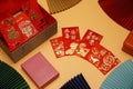 Money cheats and Chinese New Year red packets are placed on an orange background,pictured text: prosperous, springtime text space