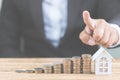 Money of coin stack step up growing growth with model white house on wooden table. Property investment Royalty Free Stock Photo