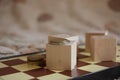 Money coins on chess board and wooden cubes, concept business background Royalty Free Stock Photo