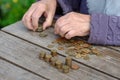 Money, coins, the grandmother on pension and the concept of life, minimum - wrinkled hands of the old woman touch coins on a woode Royalty Free Stock Photo