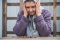 Money, coins, grandmother pensioner and the concept of subsistence minimum - old woman sad looking at the coins