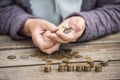 Money, coins, the grandmother on pensions and a concept of a living minimum - in hands of the old woman isn`t enough money Royalty Free Stock Photo