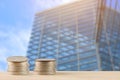 Money coins pile on table with building in urban Royalty Free Stock Photo