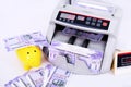 Money counting machine with new Indian currency and piggy bank Royalty Free Stock Photo