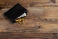 Money and Crypto-currency in the physical purse. The concept of virtual money in the wallet. On a wooden table. Royalty Free Stock Photo