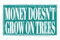 MONEY DOESN`T GROW ON TREES, words on blue grungy stamp sign