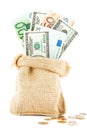 Money dollars and euros in the linen bag and coins scattered near Royalty Free Stock Photo