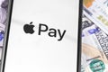 Money, dollars, iPhone with Apple Pay logo