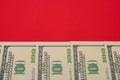 Money, dollars neatly laid out on a red background with a copy of space
