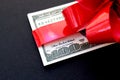 Money dollars wrapped in a bow on a gift Royalty Free Stock Photo