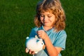 Money dream. Dreamy kids face. Daydreamer child portrait close up. Dreams and imagination. Child boy putting in piggy Royalty Free Stock Photo