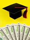 Money for education, diploma and academic cap of the student. Financial opportunity to save and spend on College or University