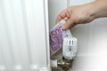 Money, 500 euro banknotes on valve of heating radiator regulator, rising prices for utilities, heating costs on household budgets