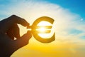 Money euro symbol in businessman hand on sunset sky background. Business concept idea