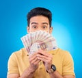 Money, fan and man with wow face  on blue, studio background for winning, cash surprise or financial profit Royalty Free Stock Photo