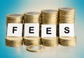 Fees inscription on stacks of coins Royalty Free Stock Photo