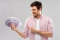 Smiling young man showing fan of euro money Royalty Free Stock Photo