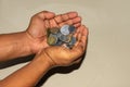 money and finances concept - close up of man's cupped hands showing Indian coins Royalty Free Stock Photo