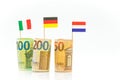 Money and flags of Germany, France and Italy euro bills on a white background.euro inflation.Changes in the budget Royalty Free Stock Photo