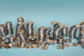 Money in form of unstable columns of coins. Saving money, business, finance, banking concept. Many coins in random piles