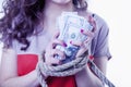 Money is freedom concept. Woman`s hands bound with rope as symbo