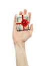 Money gift. American dollars cash with red ribbon in male hand isolated on white background. US Dollars 100 banknote Royalty Free Stock Photo