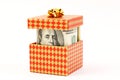 Money in gift box with gold bow Royalty Free Stock Photo
