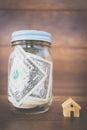 Money in glass bottle ,Saving to buy a house Royalty Free Stock Photo