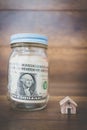 Money in glass bottle ,Saving to buy a house Royalty Free Stock Photo