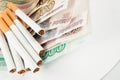 Money and group of cigarettes Royalty Free Stock Photo