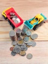 Money growth concept coin tower with truck toys Royalty Free Stock Photo