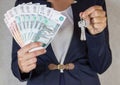 Money in hand. Keys in hand Royalty Free Stock Photo