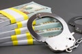 money and handcuffs. financial crime,