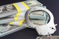 money and handcuffs. financial crime