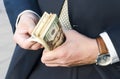 Money in hands close up. a man in a business suit counts American dollars. cash payment. repay debts. financial airbag Royalty Free Stock Photo