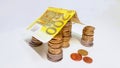 Money home house roof euro banknote and coins Royalty Free Stock Photo