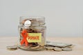 Money jar full of coins with orange ribbon and Donate label - Concept of leukemia, kidney cancer, multiple sclerosis and animal Royalty Free Stock Photo