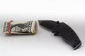 Money and knife on white background.