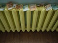 Money laundering concept image with copyspace. Euro banknotes drying on yellow radiator