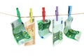 Money laundering. Euro banknotes hanging on clothesline against white background Royalty Free Stock Photo