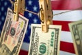 Money laundering with US dollars hung out to dry on American flag background. Dollar bills hanging on clothesline, close Royalty Free Stock Photo