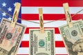 Money laundering with US dollars hung out to dry on American flag background. Dollar bills hanging on clothesline, close Royalty Free Stock Photo