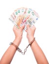 Money and the law. Hand in handcuffs hold euro banknotes. Financial debts. Payments of taxes, cash money. Royalty Free Stock Photo