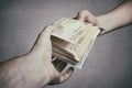 Money Loan. Bank officer loaning stack of euro banknotes money.