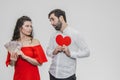 Money and love. Dollar hands. A man holds a red heart in his arms a wife holds the money. Valentine`s Day Royalty Free Stock Photo